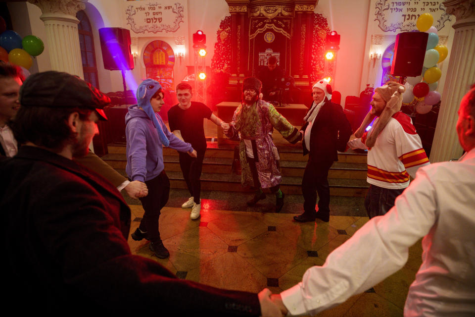 Men of the Ukrainian Jewish community dance during Purim celebrations and a festive meal at the Great Choral Synagogue in Kyiv, Ukraine, Sunday, March 24, 2024. (AP Photo/Vadim Ghirda)