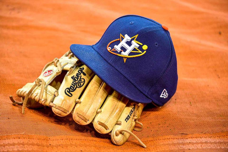 <p> Logan Riely/Getty </p> A Houston Astros game hat and glove.