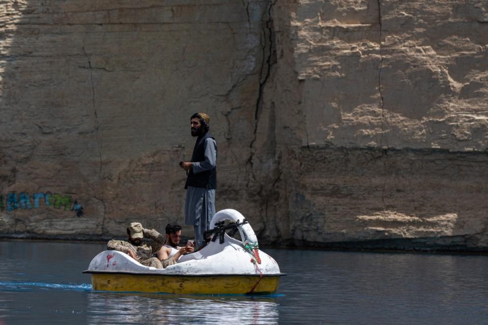 Taliban members paddle in a boat as they and Afghan families enjoy a visit to one of the lakes in Band-e Amir National Park (Getty)