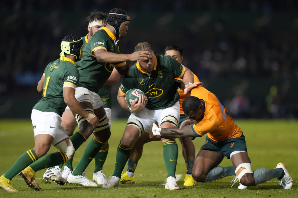 South Africa's captain Duane Vermeulen, centre, is tackled by Australia's Suliasi Vunivalu during the Rugby Championship test match between South Africa and Australia at Loftus Versfeld stadium in Pretoria, South Africa, Saturday, July 8, 2023. (AP Photo/Themba Hadebe)