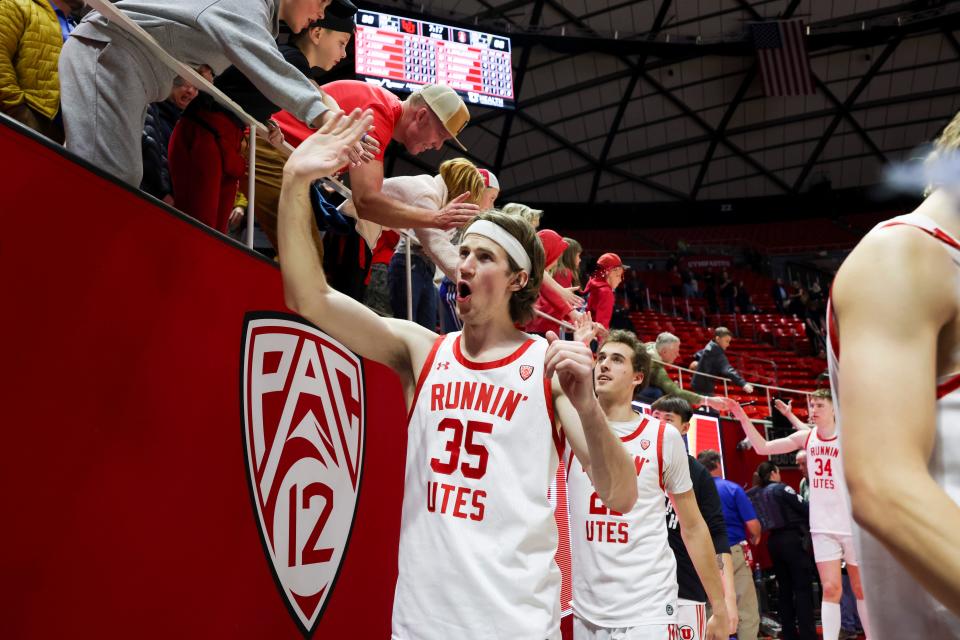 Utah Utes center Branden Carlson (35) slaps hands with fans after the win against the Stanford Cardinal at Jon M. Huntsman Center.