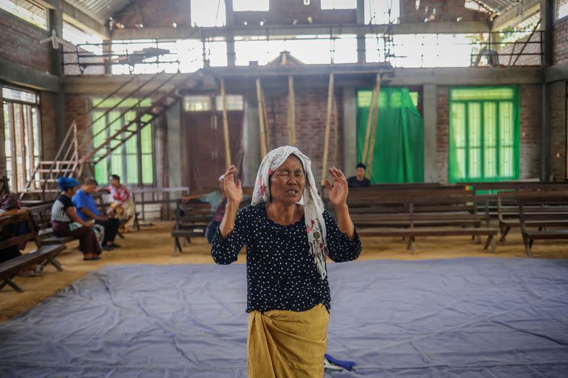 A Kuki woman prays inside a church at Kangvai village in Churachandpur district