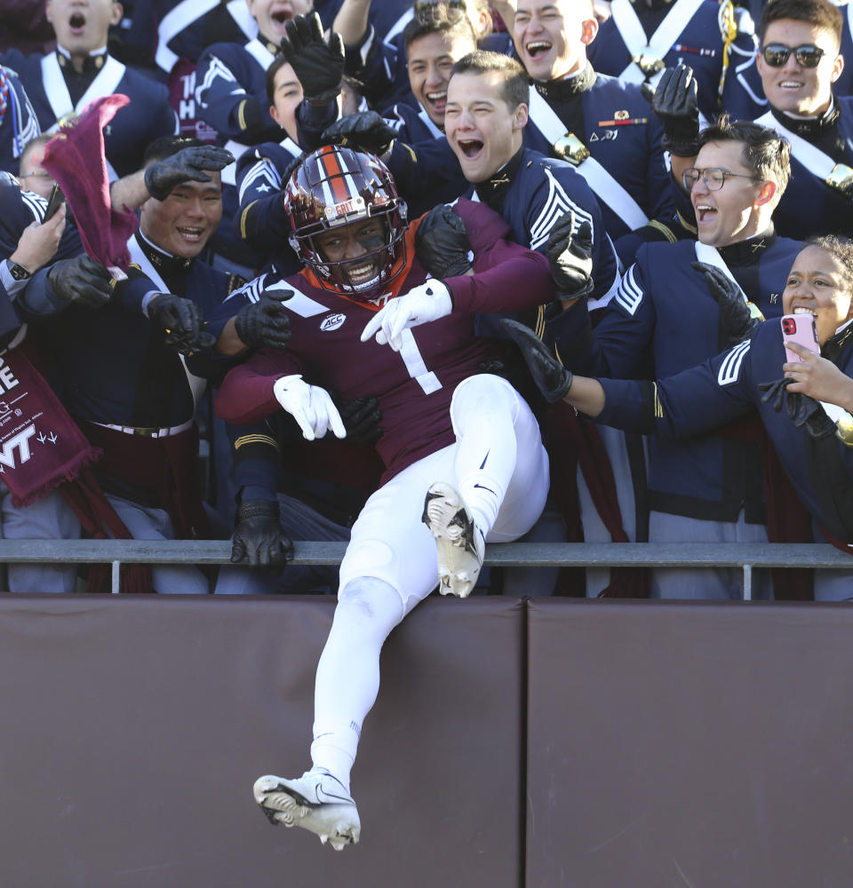 Virginia Tech defensive back Chamarri Conner (1) celebrates with members of the Corps of Cadets at the start of an NCAA college football game against Duke in Blacksburg Va., Saturday, Nov. 13 2021. (Matt Gentry/The Roanoke Times via AP)