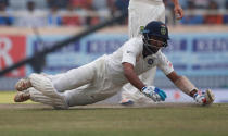 India's Cheteshwar Pujara dives to avoid being run out. REUTERS/Adnan Abidi