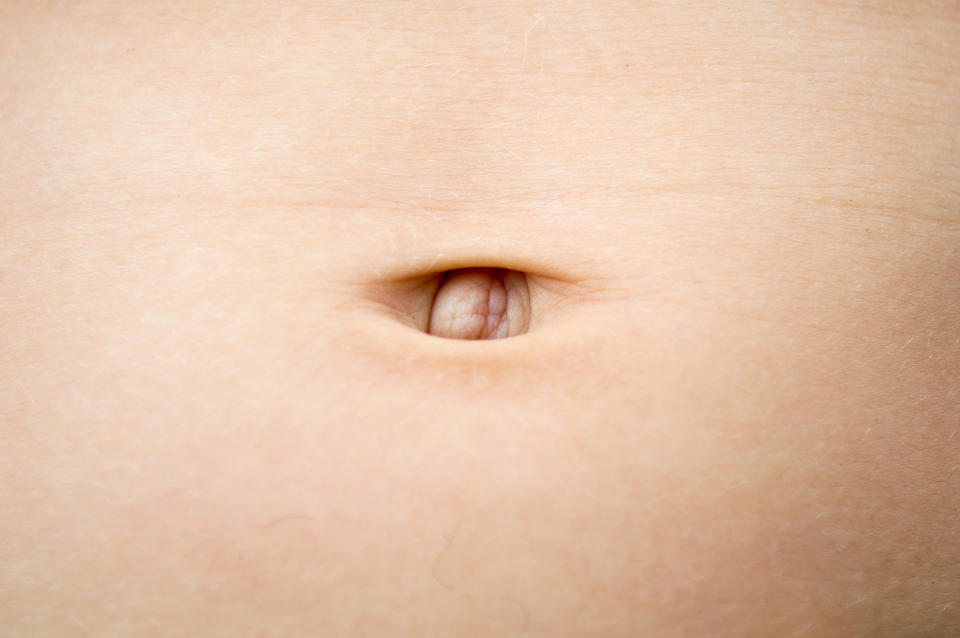 Close-up of a human belly button on a smooth skin surface