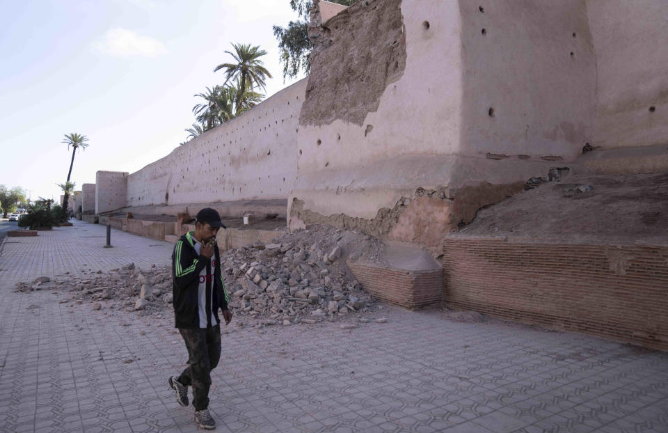 A man walks past a damaged wall of the historic Medina of Marrakech, after after an earthquake in Morocco, Saturday, Sept. 9, 2023. A rare, powerful earthquake struck Morocco late Friday night, killing more than 600 people and damaging buildings from villages in the Atlas Mountains to the historic city of Marrakech. (AP Photo/Mosa'ab Elshamy)