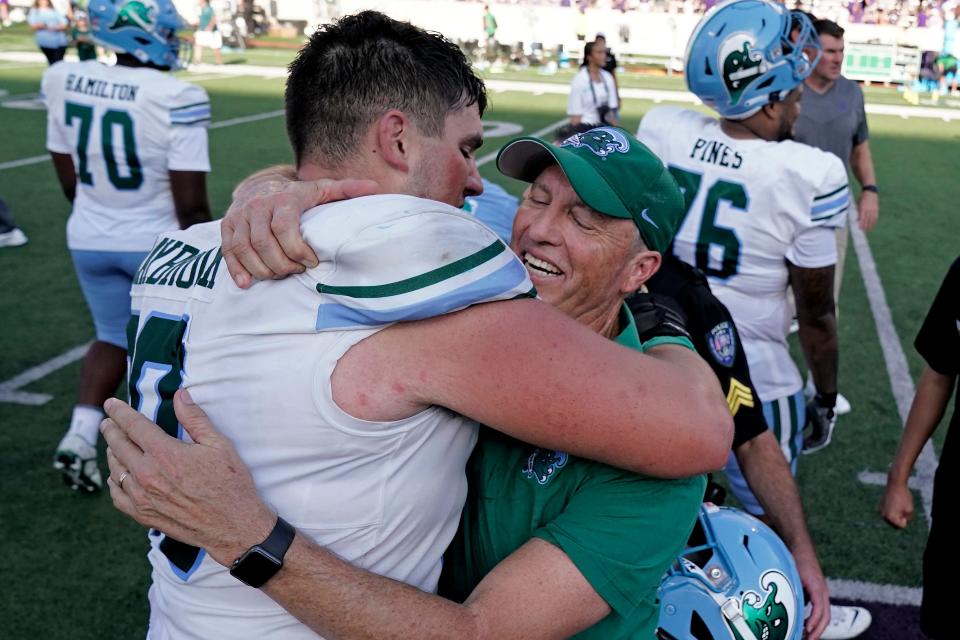 Tulane head coach Willie Fritz celebrates with Tulane offensive lineman Joey Claybrook after their NCAA college football game against Kansas State Saturday, Sept. 17, 2022, in Manhattan, Kan. Tulane won 17-10. (AP Photo/Charlie Riedel)