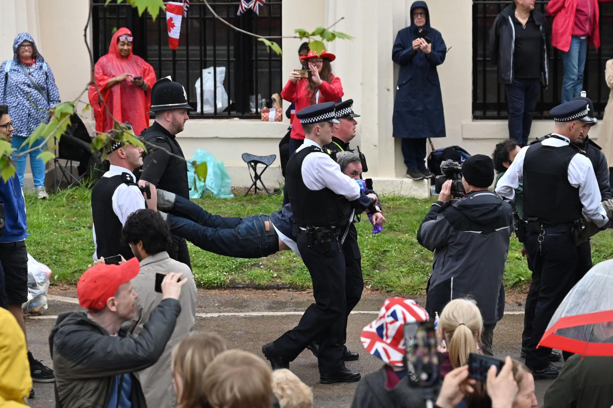 Police officers take away protesters near to the 'King's Procession', a journey of two kilometres from Buckingham Palace to Westminster Abbey on Saturday (Getty)