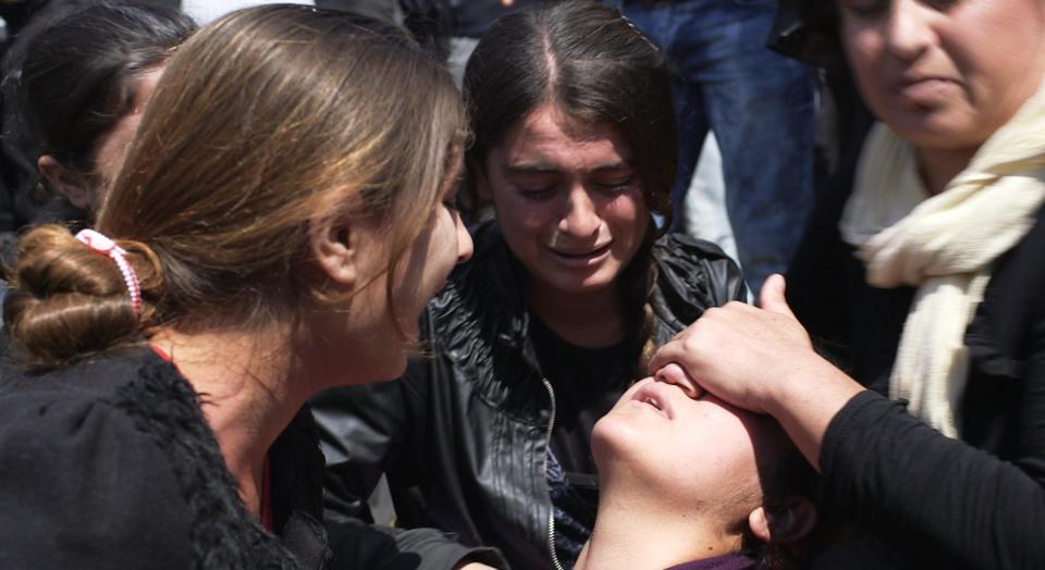 A young Yazidi woman suffers a post traumatic collapse during a protest in a camp for displaced people.