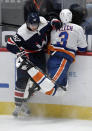 Washington Capitals left wing Carl Hagelin (62) and New York Islanders defenseman Adam Pelech (3) collide along the boards during the second period of an NHL hockey game Tuesday, Jan. 26, 2021, in Washington. (AP Photo/Nick Wass)