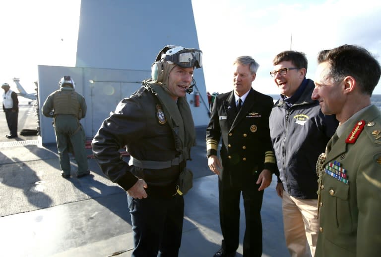 Australian PM Tony Abbott (front L) is greeted by US Vice Admiral Robert L Thomas (3rd R), US Ambassador to Australia John Berry (2nd R) and Australian Major General Stuart Smith (R) on the USS Blue Ridge in Sydney Harbour on July 3, 2015