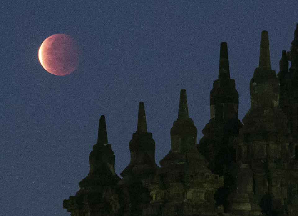 YOGYAKARTA, INDONESIA - MAY 26, 2021 : A view of total lunar eclipse called Super blood moon at Plaosan Buddha temple in Yogykarta, Indonesia on May 26, 2021. (Photo credit should read Kasan / Sijori Images/Barcroft Media via Getty Images)