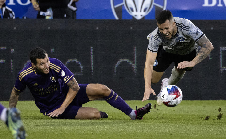 Orlando City defender Kyle Smith, left, and CF Montreal defender Aaron Herrera collide during the first half of an MLS soccer game in Montreal, Saturday, May 6, 2023. (Allen McInnis/The Canadian Press via AP)