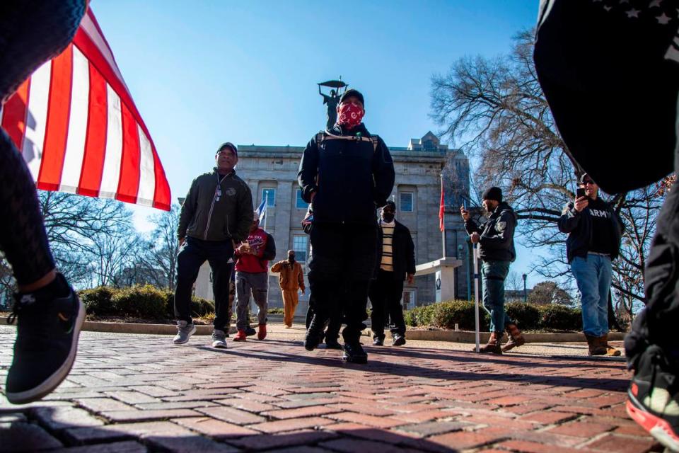 A group of veterans organized by Walk for Vets, an organization campaigning to bring awareness to veterans suicides, march Monday, Feb 14, 2022 at the State Capitol. The group walked 2.2 miles through downtown Raleigh to raise awareness of the roughly 22 veterans who die by suicide each day.