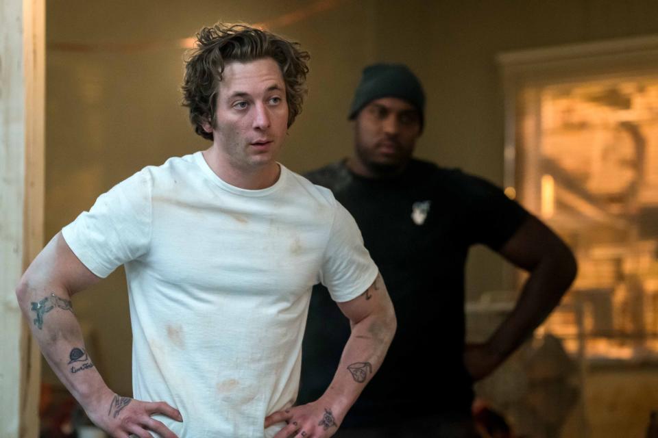 Jeremy Allen White and Lionel Boyce in a dark t-shirt standing next to each other, in a scene from The Bear