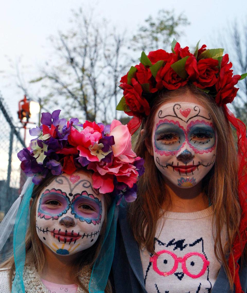 Claudia and Cecilia Garces wore a traditional face paint and headdress at the Festival del Dia de los Muertos at Living Arts and Science Center in Lexington, Ky., Sunday, November 1, 2015. Photo by Matt Goins