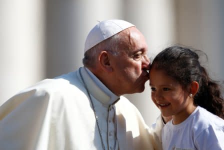 Pope Francis kisses a child during the Wednesday general audience in Saint Peter's square at the Vatican, June 20, 2018. REUTERS/Stefano Rellandini