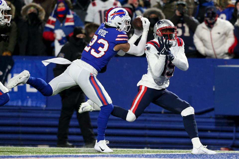 Buffalo Bills safety Micah Hyde (23) makes an interception against New England Patriots wide receiver Nelson Agholor (15) during the first half of an NFL wild-card playoff football game, Saturday, Jan. 15, 2022, in Orchard Park, N.Y. (AP Photo/Joshua Bessex)