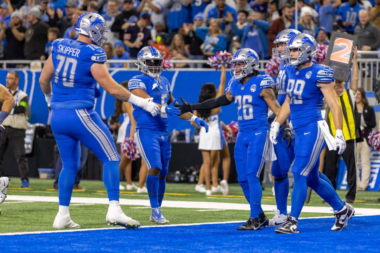 Detroit Lions running back Jahmyr Gibbs (26) celebrates his a touchdown against the Chicago Bears with teammates during the first half at Ford Field.