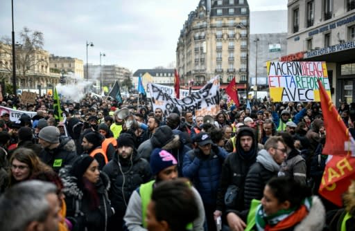 Protesters take part in a demonstration near Gare de l'Est train station in Paris on December 26