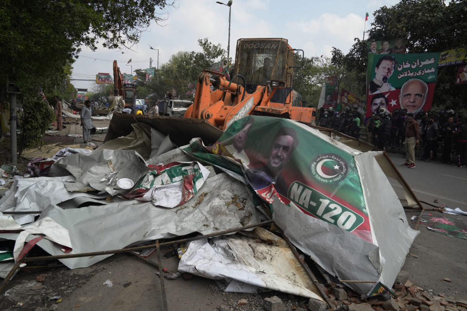 Police use a crane to remove tents and other stuff from outside the residence of former Prime Minister Imran Khan during a search operation in the Khan's resident, in Lahore, Pakistan, March 18, 2023. Pakistani police stormed former Prime Minister Khan's residence in the eastern city of Lahore on Saturday and arrested 61 people amid tear gas and clashes between Khan's supporters and police, officials said. (AP Photo/K.M. Chaudary)