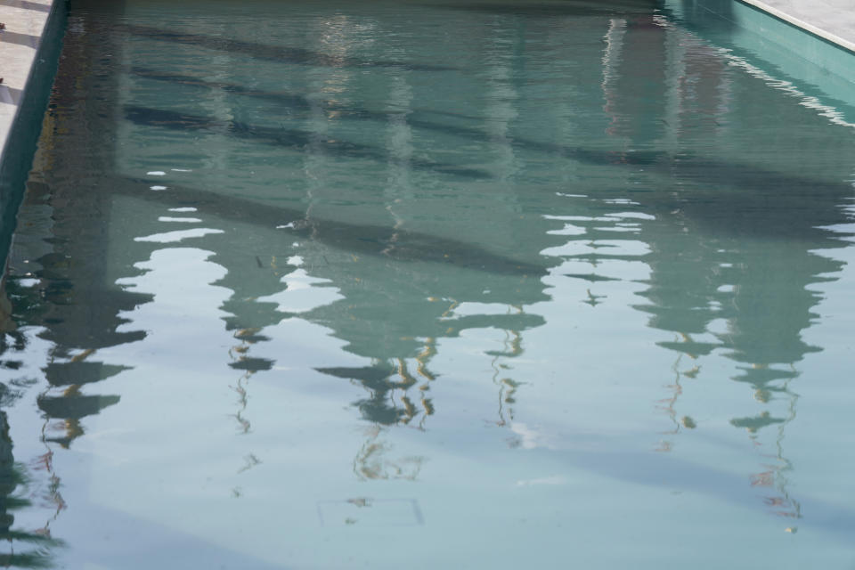 A reflection of the first stone-built Hindu temple in the Middle East, belonging to Bochasanwasi Akshar Purushottam Swaminarayan Sanstha is seen in water before its opening ceremony in Abu Mureikha, 40 kilometers (25 miles) northeast of Abu Dhabi, United Arab Emirates, Wednesday, Feb. 14, 2024. (AP Photo/Kamran Jebreili)