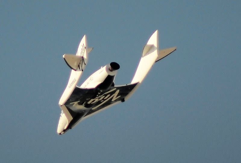 FILE PHOTO: File photo of Virgin Galactic's SpaceShipTwo flies over the Mojave Desert shortly before successfully completing a test flight that broke the sound barrier