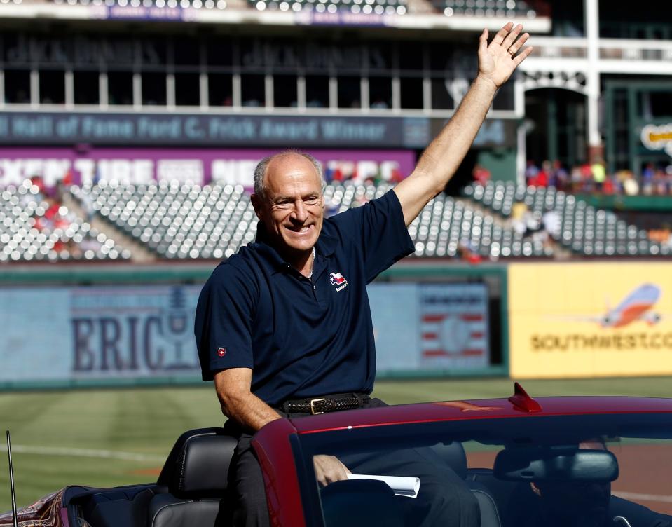 Texas Rangers radio announcer Eric Nadel waves to fans before being presented with the 2014 Ford C. Frick Award prior to a game against the Los Angeles Angels at Globe Life Park in Arlington on July 12, 2014.