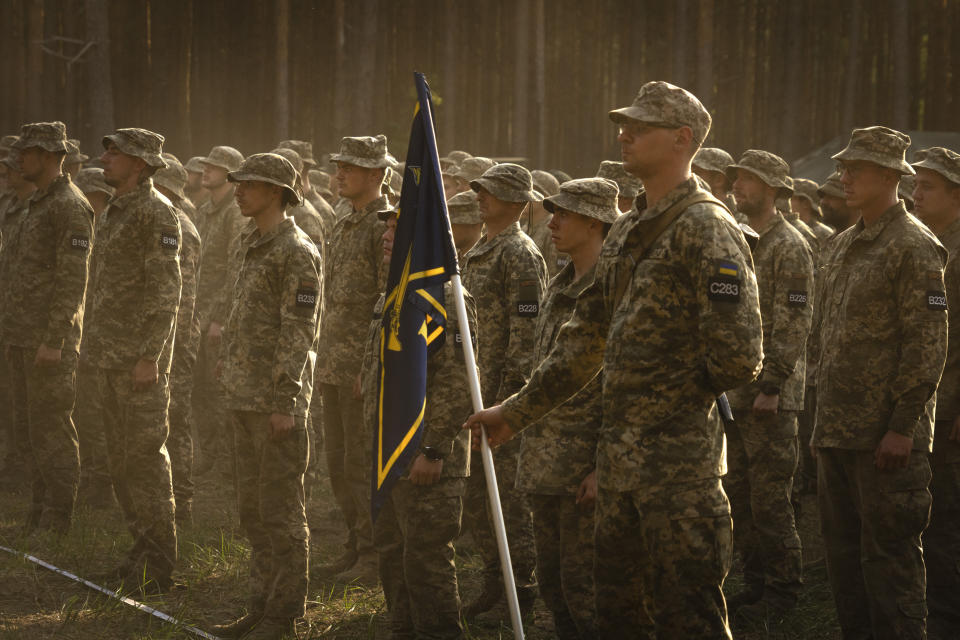 Newly recruited soldiers attend a ceremony as they celebrate the end of their training at a military base close to Kyiv, Ukraine, Monday, Sept. 25, 2023. As the third year of war begins, the most sensitive and urgent challenge pressing on Ukraine is whether it can muster enough new soldiers to repel – and eventually drive out – an enemy with far more fighters at its disposal. (AP Photo/Efrem Lukatsky)