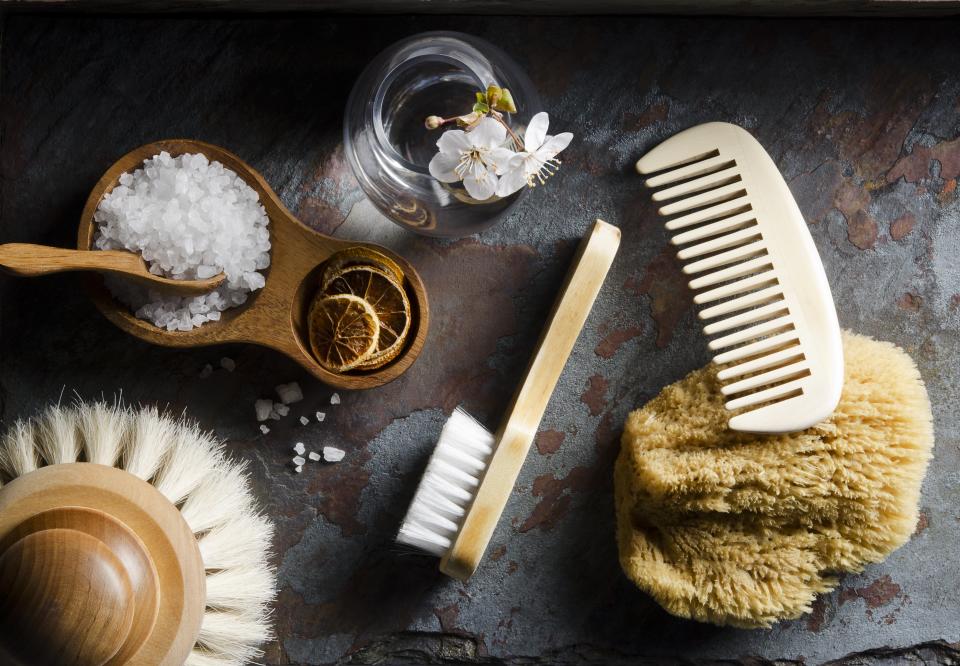 Flatlay image of bath salts and dry brushes.