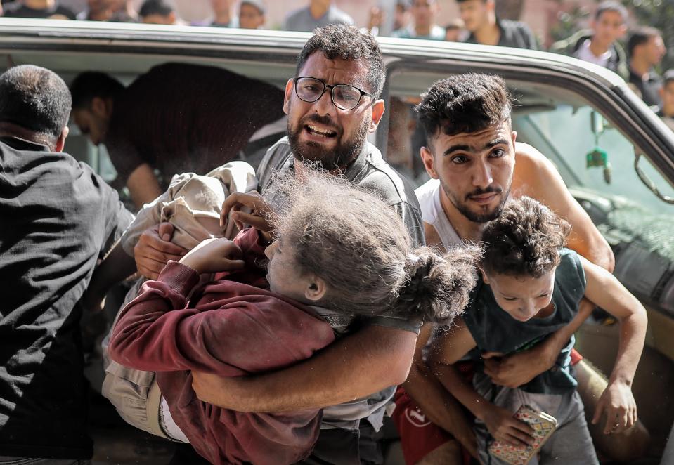 KHAN YUNIS, GAZA - OCTOBER 15: (EDITORS NOTE: Image depicts graphic content) Palestinians including children are brought to Nasser Hospital for treatment aftermath of Israeli airstrikes in Khan Yunis, Gaza on October 15, 2023. (Photo by Belal Khaled/Anadolu via Getty Images)