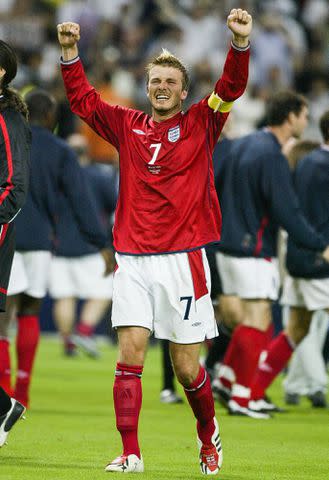 <p>Simon Bruty/Anychance/Getty</p> David Beckham celebrates after winning the 1st round match between Argentina and England during the 2002 FIFA World Cup.