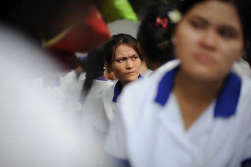 Myanmar labourers from a garment factory are seen sitting in protest outside their factory after staging a walkout, at the Hlaing Thar Yar industrial zone in Yangon, on May 16. Silenced for years under junta rule, Myanmar's workers are finding their voice to demand better pay -- with teething problems expected as staff and employers come to terms with unprecedented labour reform