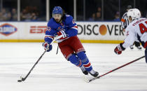 New York Rangers' Mika Zibanejad (93) skates with the puck while being defended by Washington Capitals' Martin Fehervary (42) during the second period of an NHL hockey game Thursday, Feb. 24, 2022, in New York. (AP Photo/John Munson)
