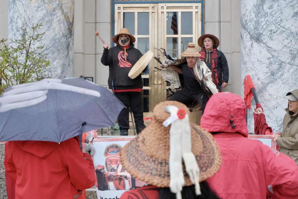 Jennifer Brown plays the drum while Jarrell Williams dances at an MMIP march on the Capitol steps in Juneau on May 5, 2024. (Photo by Claire Stremple/Alaska Beacon)
