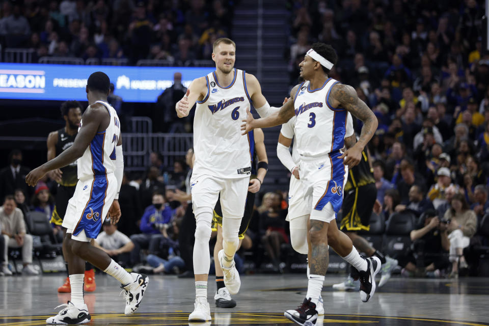 Washington Wizards center Kristaps Porzingis (6) celebrates with teammate Bradley Beal (3) during the first half of an NBA basketball game against the Golden State Warriors in San Francisco, Monday, Feb. 13, 2023. (AP Photo/Jed Jacobsohn)