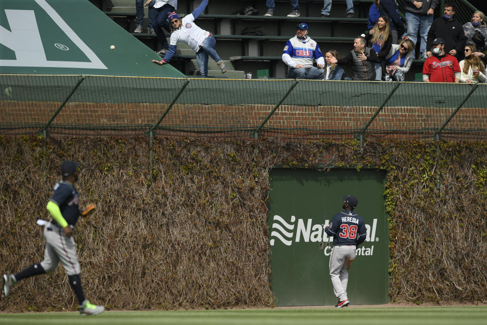 Atlanta Braves outfielders Guillermo Heredia, right, and Marcell Ozuna, left, watch Chicago Cubs' David Bote's three-run home run during the fifth inning of a baseball game Saturday, April 17, 2021, in Chicago. (AP Photo/Paul Beaty)