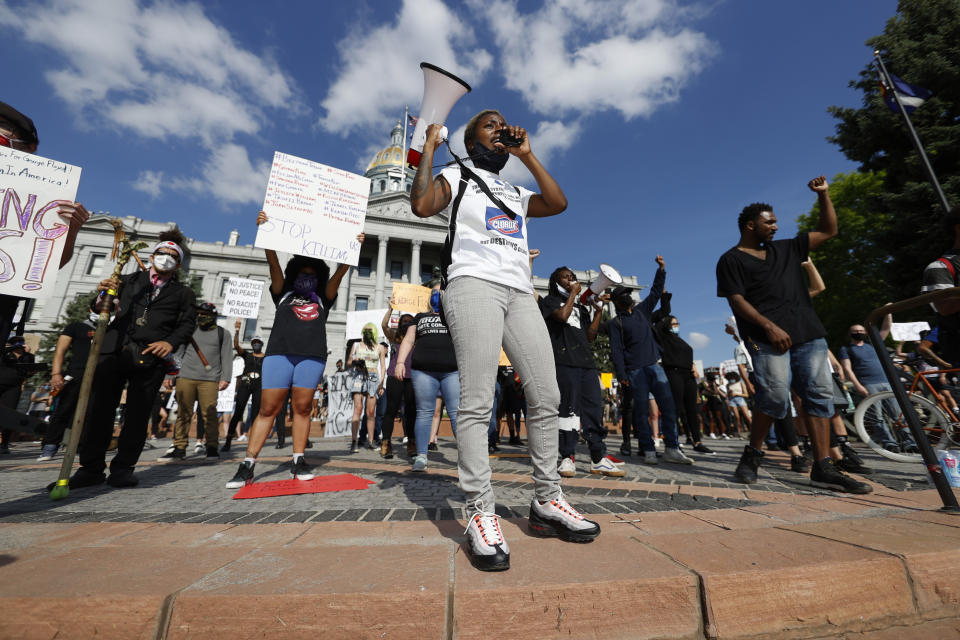 Keezy Allen leads chants during a protest outside the State Capitol over the death of George Floyd, a handcuffed black man in police custody in Minneapolis, Thursday, May 28, 2020, in Denver. Close to 1,000 protesters walked from the Capitol down the 16th Street pedestrian mall during the protest. (AP Photo/David Zalubowski)