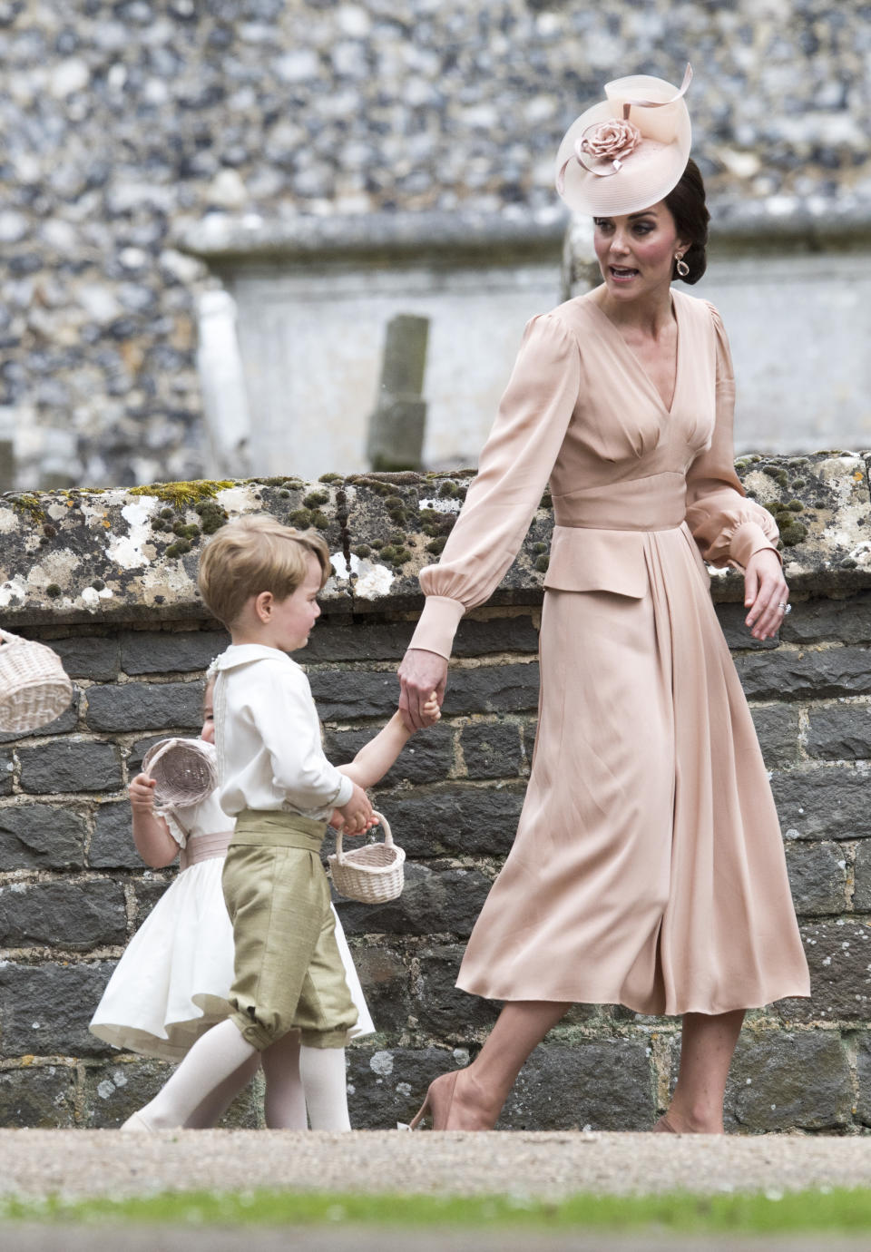 <p>Acting as the chief bridesmaid for her sister Pippa Middleton on her big day, The Duchess wore a blush-pink custom Alexander McQueen dress designed by Sarah Burton, the same lady responsible for her royal wedding gown. The Duchess paired her look with mathcing suede heels and a fascinator.<br><em>[Photo: Getty]</em> </p>