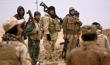 Members of the Lions of the Tigris, a group of Sunni Arab fighters and part of the Hashid Shaabi (Popular Mobilization Comimittee) take part during a military operation against Islamic State militants in Shayyalah al-Imam, Iraq November 30, 2016. REUTERS/Thaier Al-Sudani