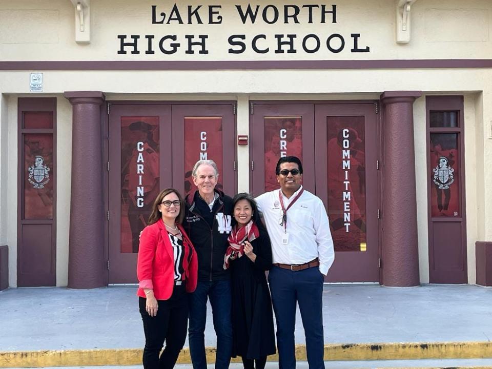 Lake Worth High School Principal Elena Villani, from left, chef Thomas Keller, Ment'or Executive Director Young Yun and Assistant Principal Christian Garate pose for a photo in front of the school.