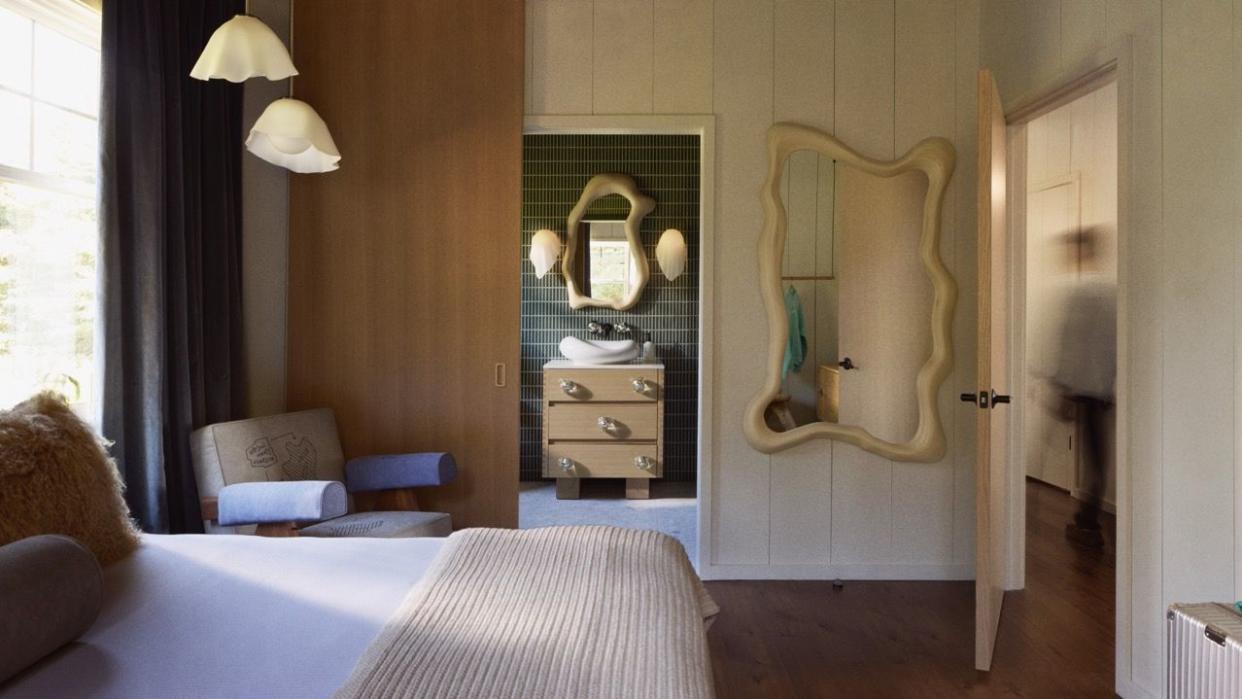 a bedroom with a large mirror