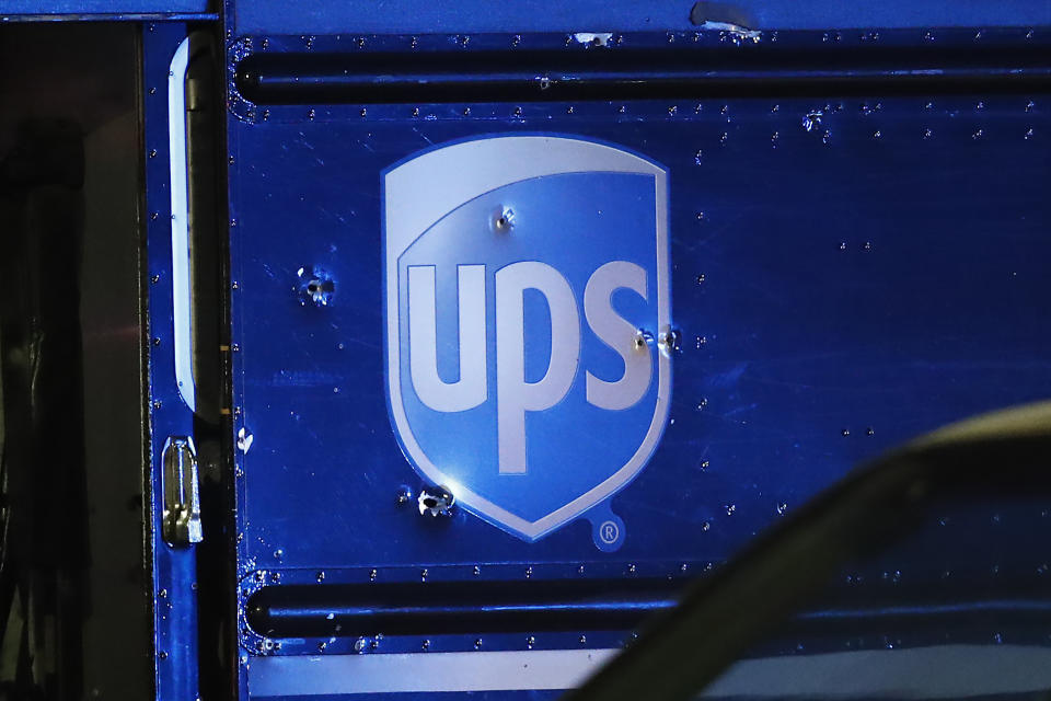 FILE- In this Dec. 5, 2019, file photo, bullet holes are seen around the UPS logo of a truck at the scene of a shooting that killed four people, including a UPS driver. The family of Frank Ordonez the UPS driver slain during the police shootout, have filed a lawsuit Wednesday, Sept. 16, 2020, against several law enforcement agencies. They say that officers acted negligently when they opened fire on two robbers who were holding him hostage inside his van. (AP Photo/Brynn Anderson, File)