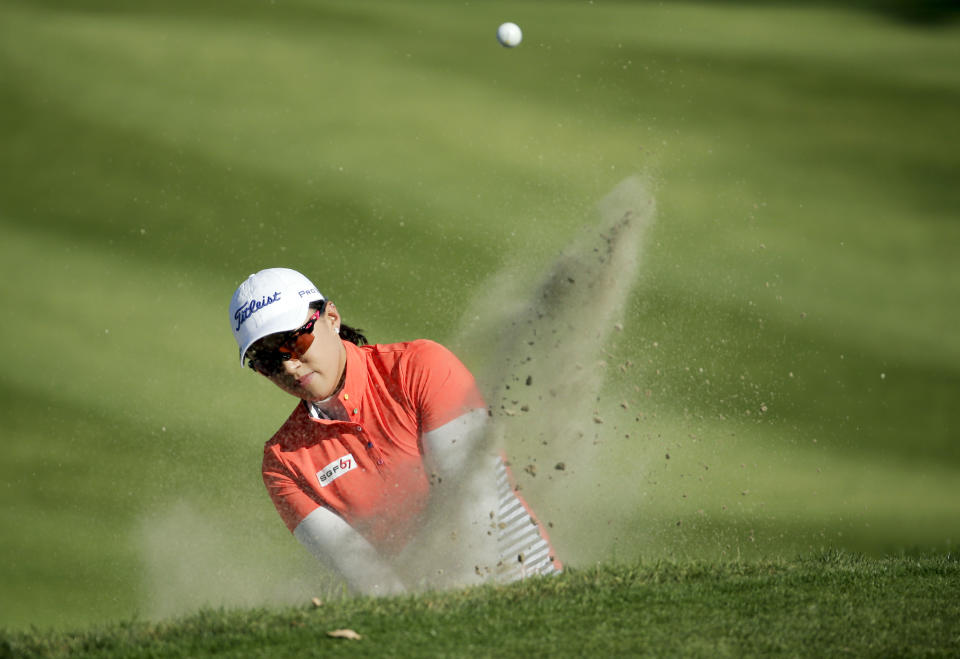 Amy Yang, of South Korea, hits from a bunker on the 15th hole during the first round at the Kraft Nabisco Championship golf tournament Thursday, April 3, 2014, in Rancho Mirage, Calif. (AP Photo/Chris Carlson)