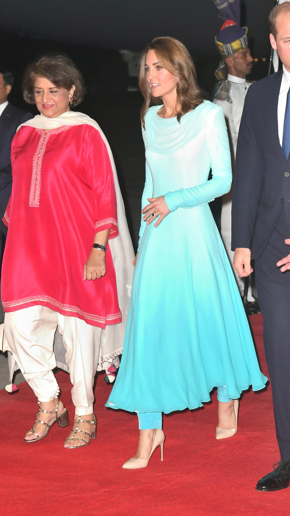 Kate wore an ombre, traditional shalwar kameez by the late Princess Diana's go-to designer for her arrival in Pakistan. A pair of nude Russell & Bromley heels finished the outfit. <em>[Photo: Getty]</em>