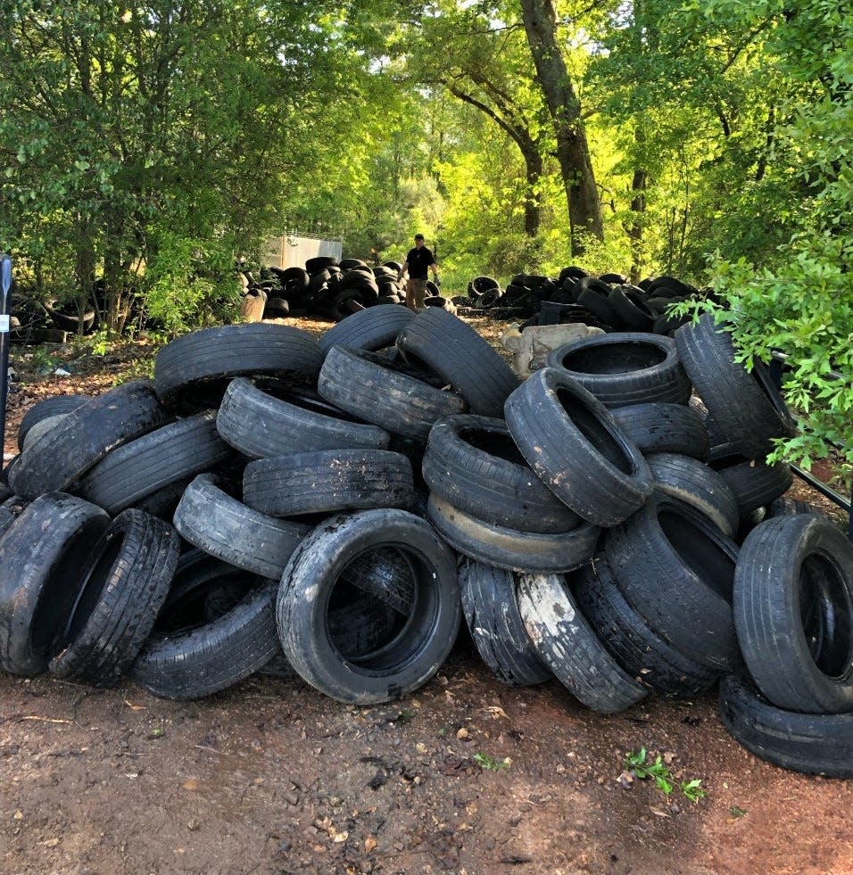 Spartanburg County Environmental Enforcement officers at one of five locations where a total of 17 tons of tires were illegally dumped, according to county officials.