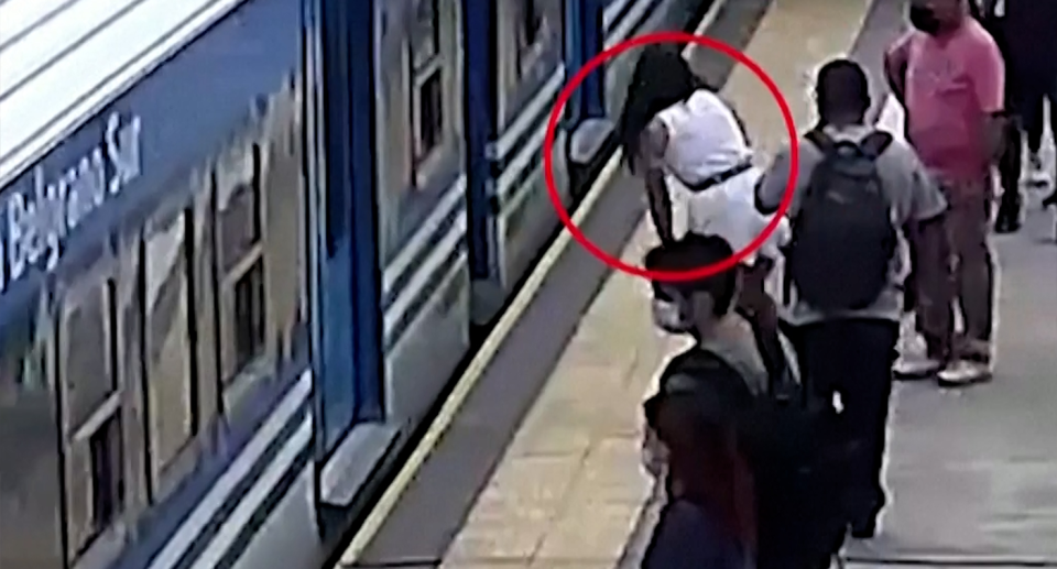 Commuters appeared not to notice a woman stumbling towards a moving train. Source: Reuters