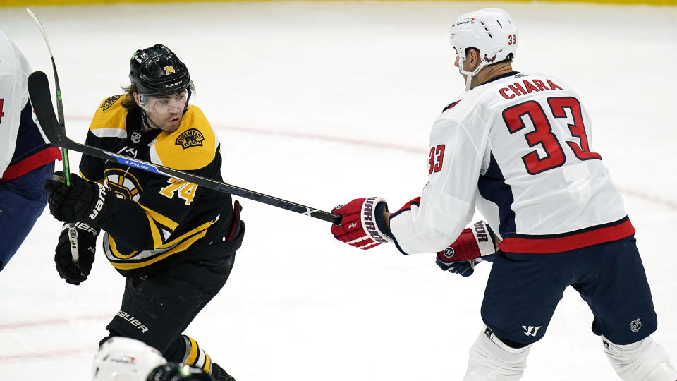 Washington Capitals defenseman Zdeno Chara (33) pokes his stick at Boston Bruins left wing Jake DeBrusk (74) during the first period of an NHL hockey game, Wednesday, March 3, 2021, in Boston. (AP Photo/Charles Krupa)