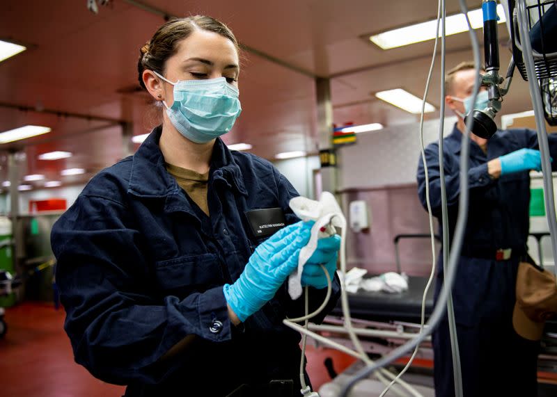 Hospitalman sanitizes medical equipment aboard the Military Sealift Command hospital ship USNS Mercy