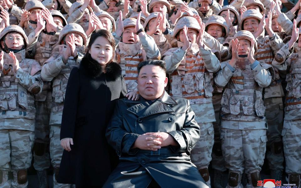 Kim Ju-ae and her father pictured with soldiers after a successful missile test - KCNA/Reuters